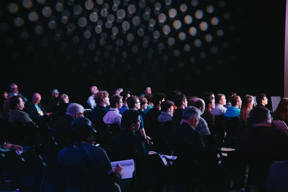 A corporate event with an audience facing a stage